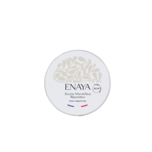 Une boîte ronde blanche étiquetée « Baume Merveilleux Réparateur-Enaya -20gr » présente un design abstrait beige et un texte français, adaptée à une utilisation sur les lèvres, le visage et le corps.