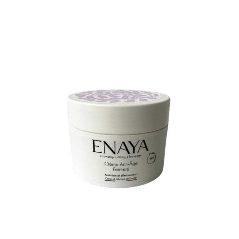Un pot blanc de Crème visage anti-âge légère & soyeuse ENAYA 40ml avec un couvercle à motif violet est présenté sur un fond blanc uni. La marque française met en avant sa formule légère et soyeuse pour une peau plus ferme, nourrie et jeune.
