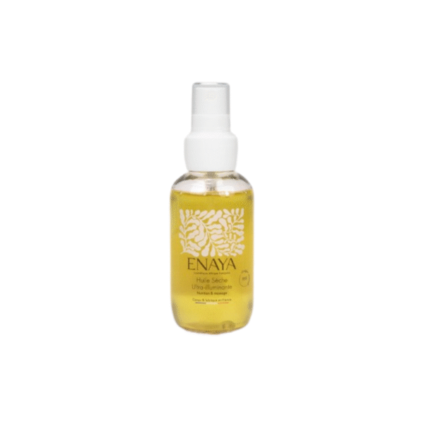 Un flacon transparent de 90 ml d'Huile sèche ultra illuminatrice-ENAYA avec une pompe blanche, un liquide jaune, un texte doré et des motifs botaniques blancs sur l'étiquette, présentés sur un fond blanc uni.