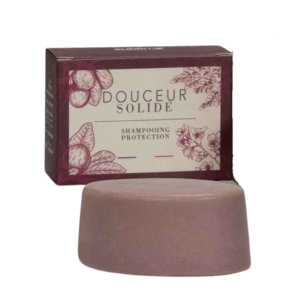 Une barre mauve Shampoing Solide Protection-Sublimo - Douceur - 65 g se trouve devant une boîte étiquetée « Douceur Solide Shampoing Protection », avec des illustrations florales.
