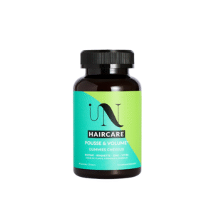 Un flacon foncé avec un bouchon noir étiqueté « Gummies - Cure pousse de cheveux - In Hair Care », contenant de la biotine, de l'ortie, du zinc et de la vitamine B6, un complément idéal pour une routine de croissance rapide et naturelle des cheveux.